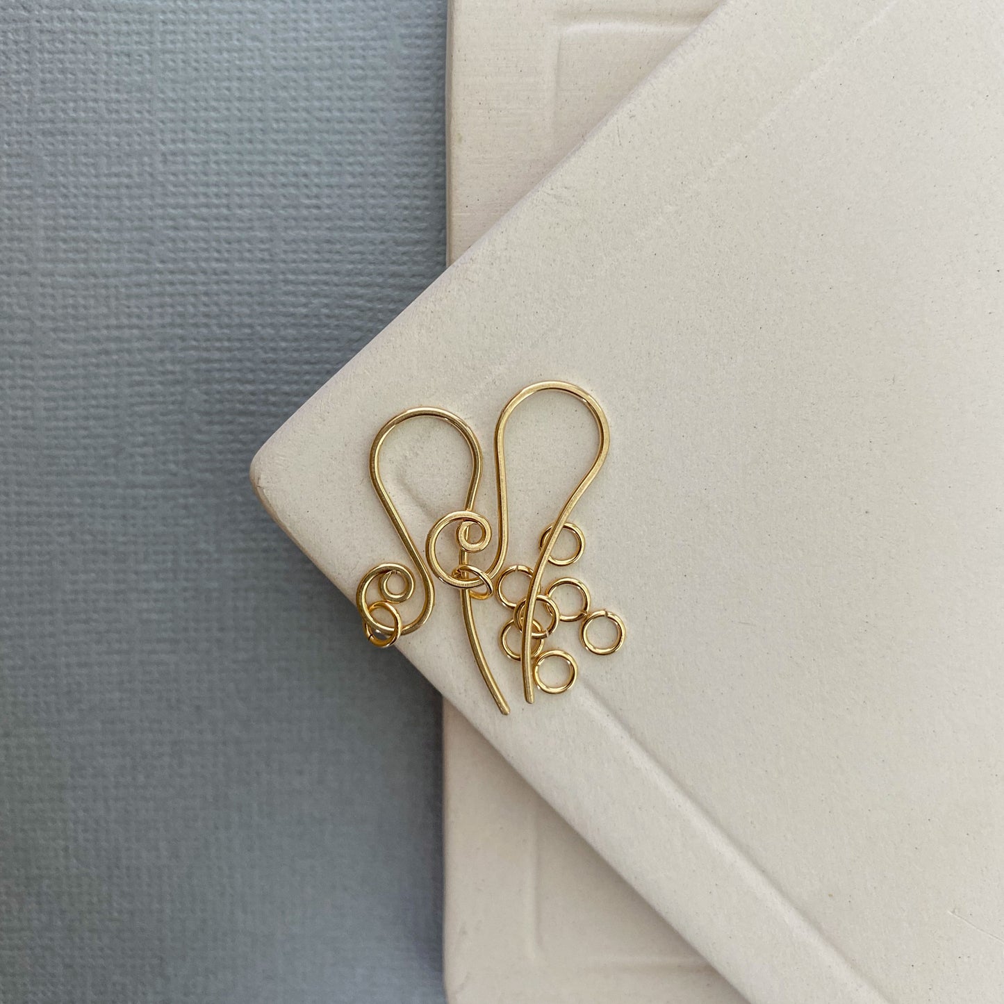 A 10K gold jump ring attaching a bracelet chain to a clasp, showing its essential role in jewelry repairs.