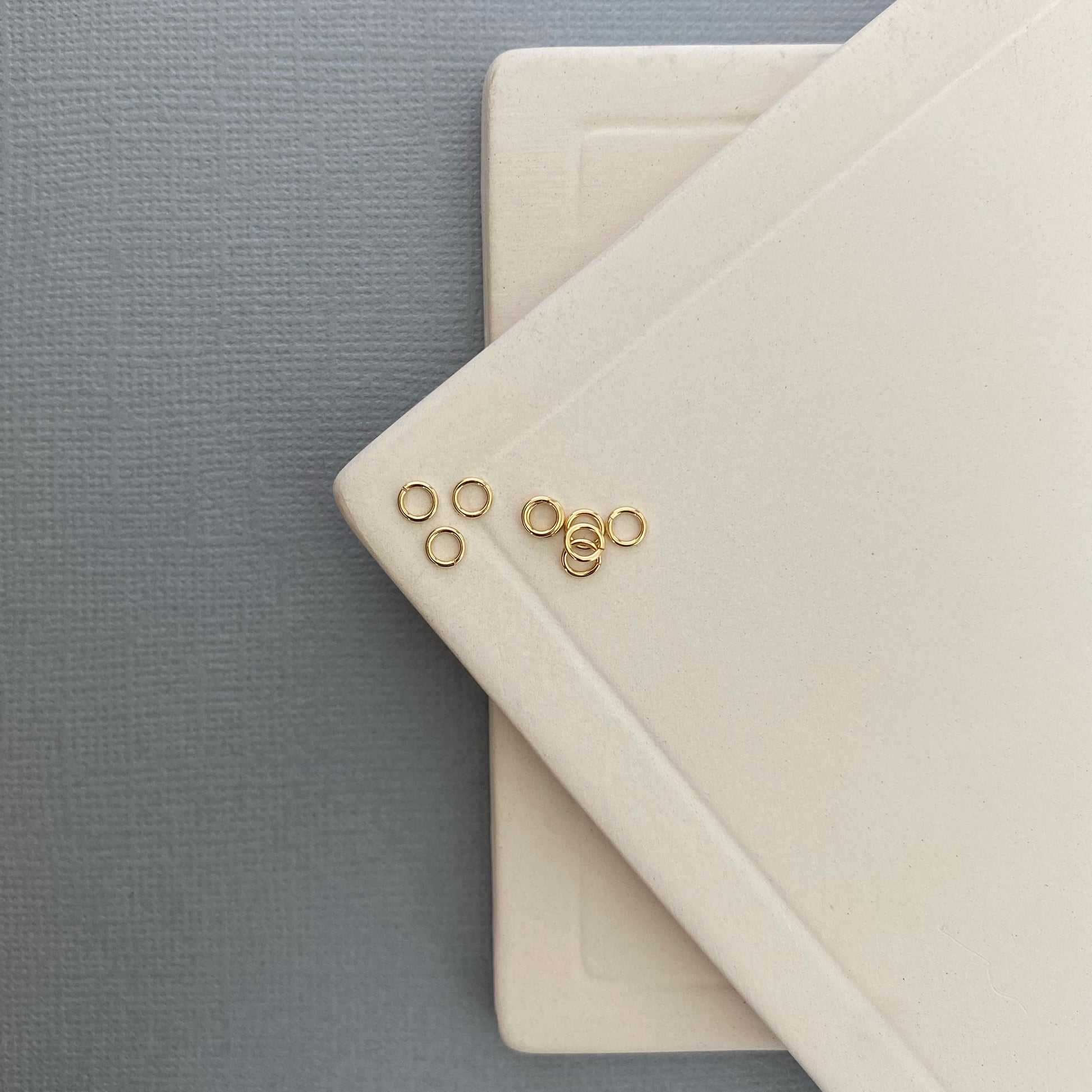 Close-up of a 10K gold jump ring on a flat surface, showcasing its smooth, polished finish and seamless design.