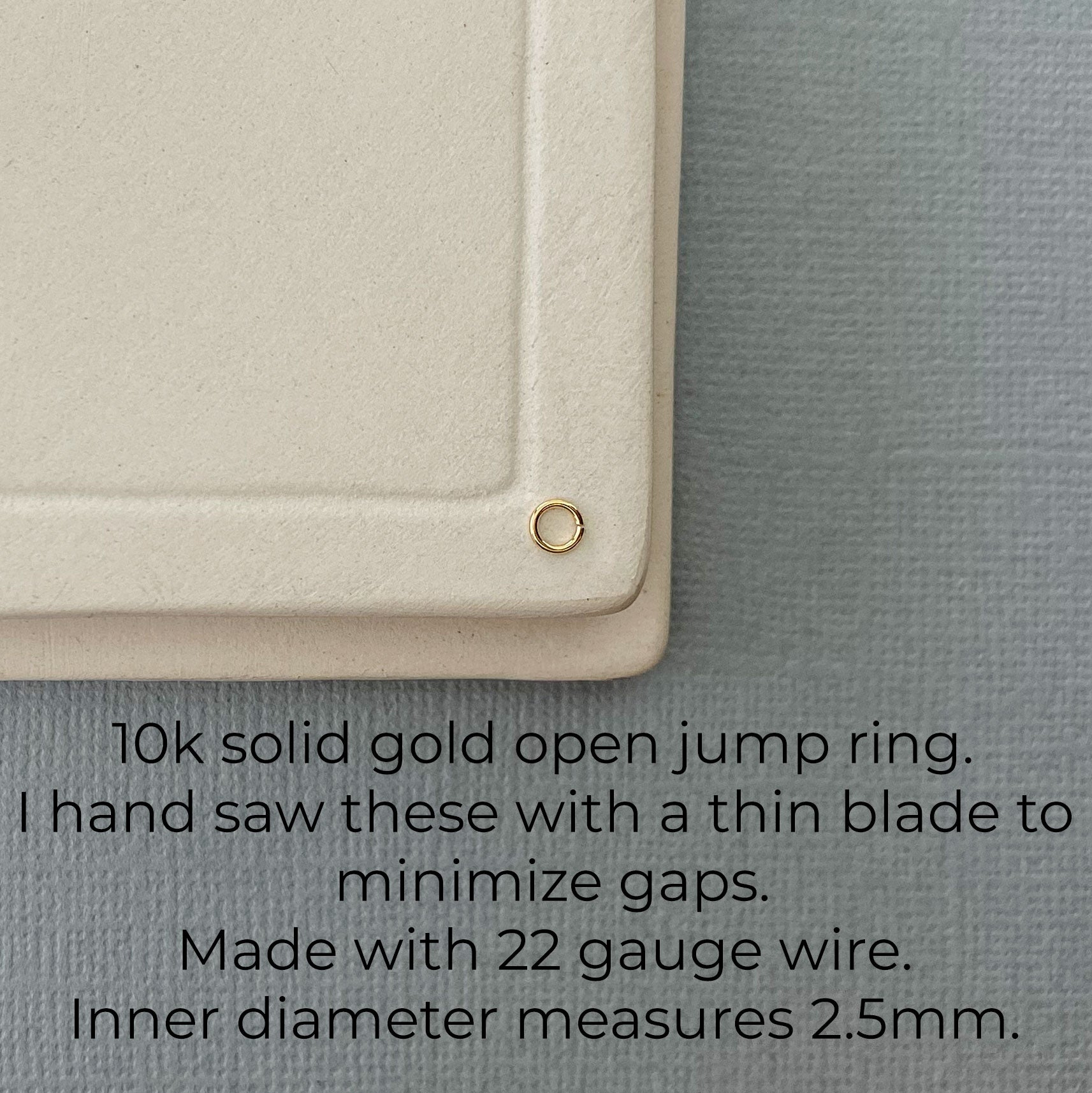 Several 10K gold jump rings laid out on a flat surface, displaying their uniform size and high-quality craftsmanship.
