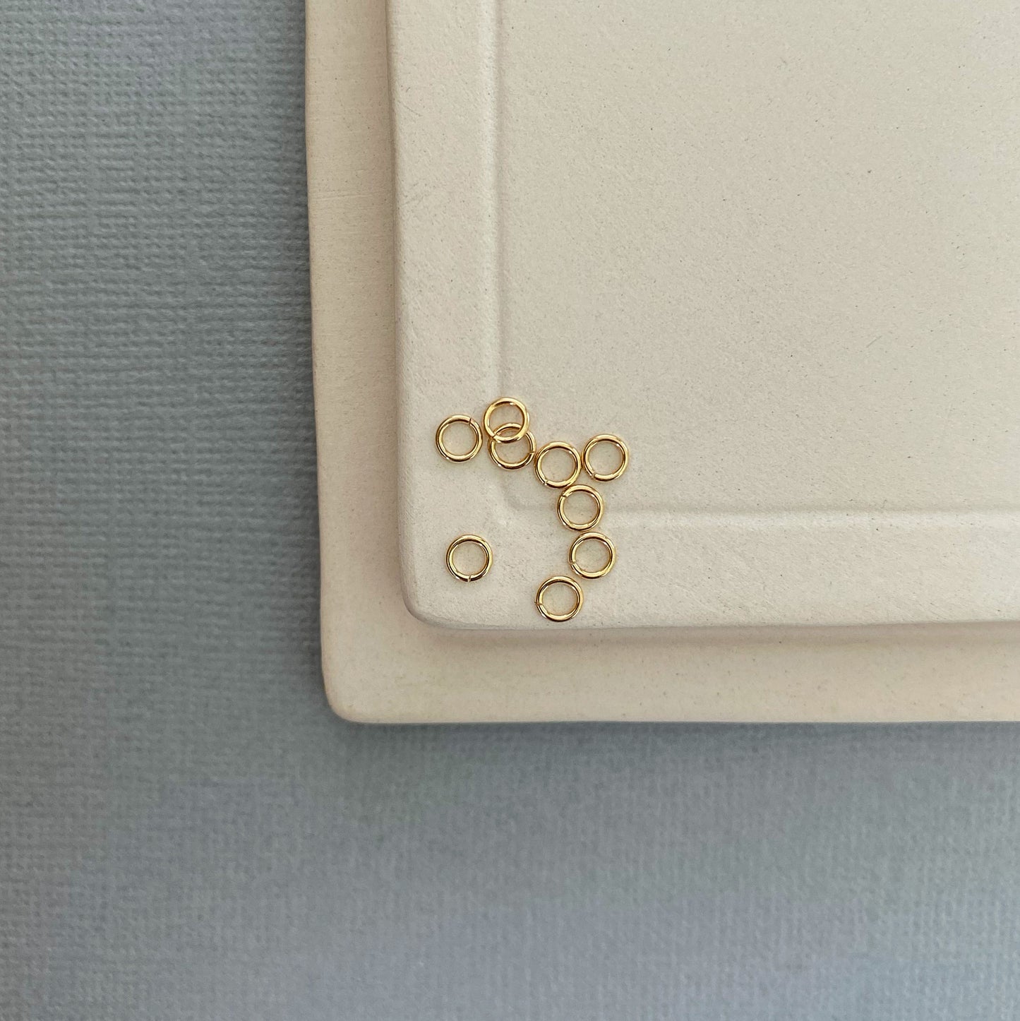 A 10K gold jump ring being used to repair a gold necklace clasp, demonstrating its strength and versatility.