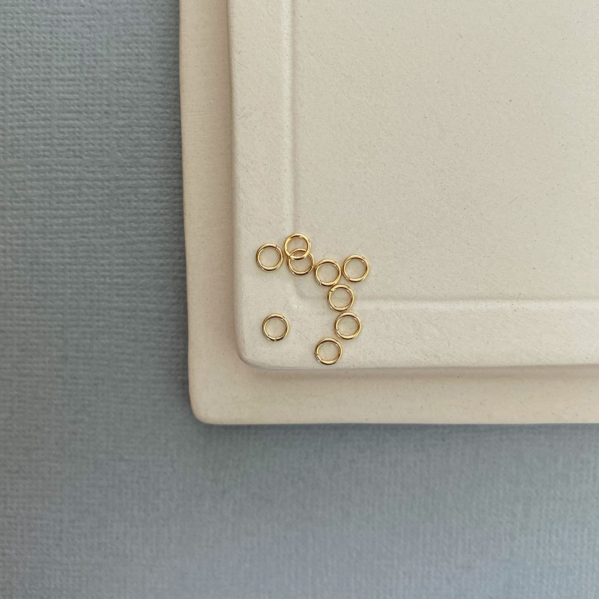 A 10K gold jump ring being used to repair a gold necklace clasp, demonstrating its strength and versatility.