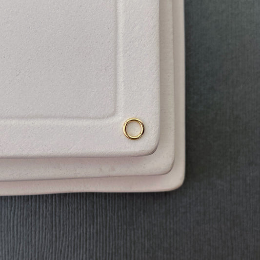 10K gold jump rings in 3mm size, made from 20-gauge solid gold wire, displayed at various angles.