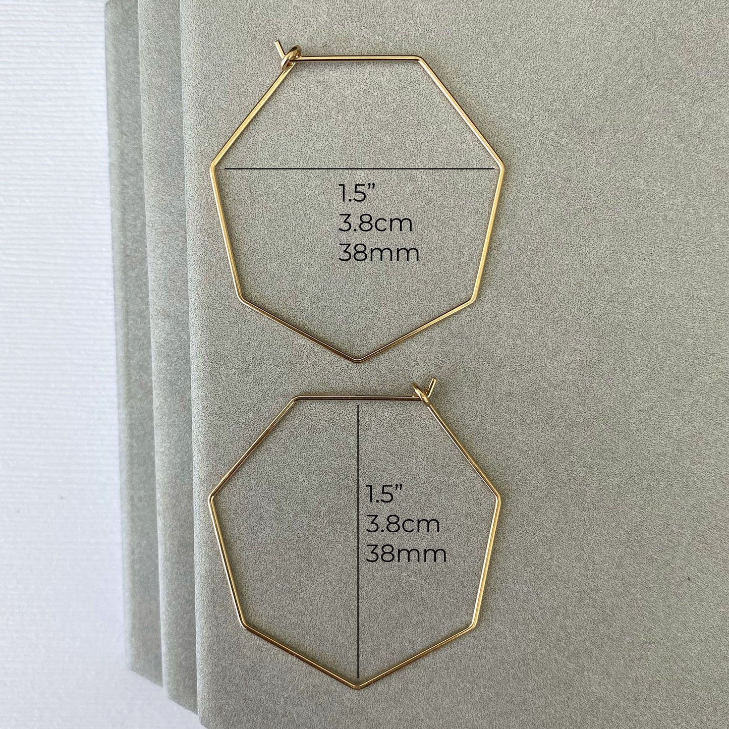 Measurements of 14k gold-filled heptagon hoop earrings showing diameter and thickness.