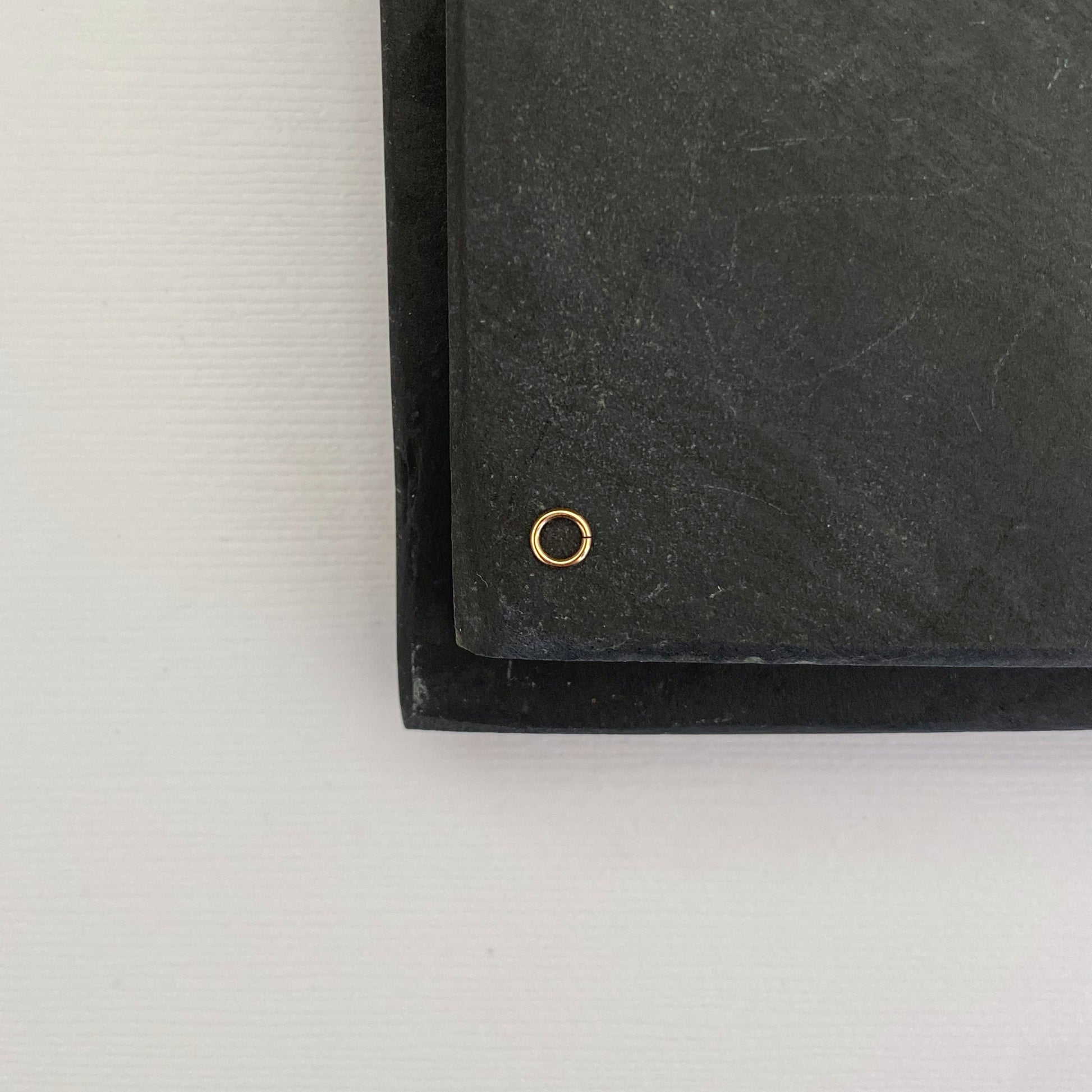 Close-up of a 14K solid gold 2.5mm jump ring, ideal for jewelry making.