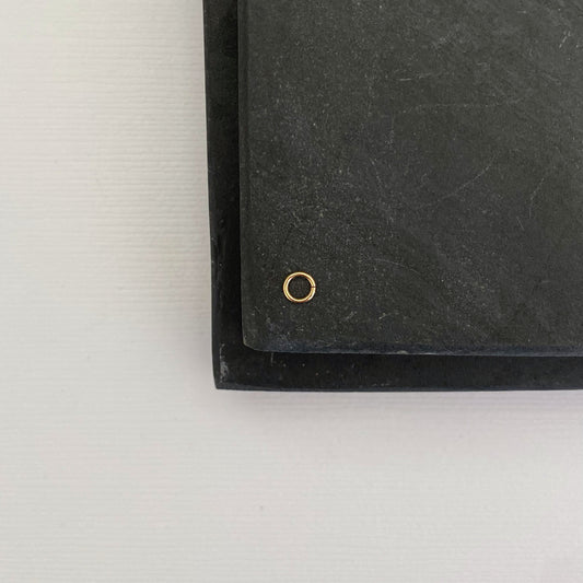 Close-up of a 14K solid gold 2.5mm jump ring, ideal for jewelry making.
