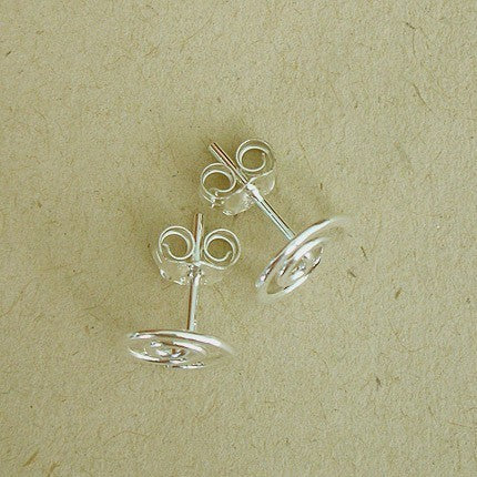 Polished sterling silver spiral studs displayed with earring backs