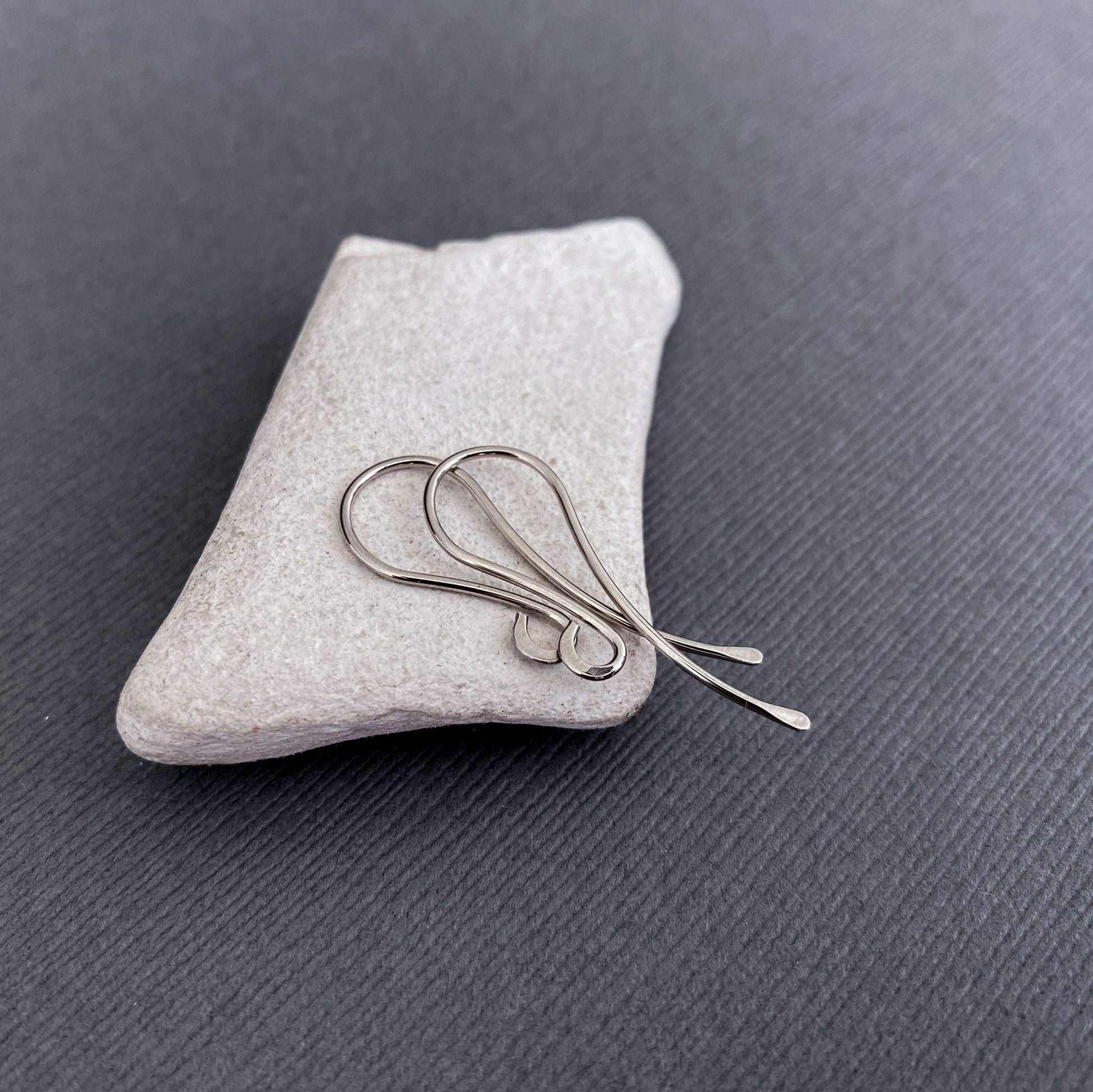 Side angle of solid 14K Palladium White Gold earring hooks, showing their smooth, handcrafted finish.