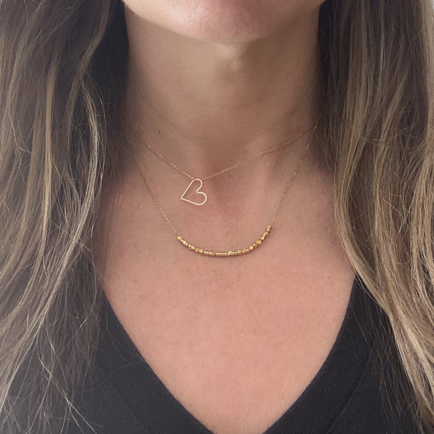 Two 14k gold filled custom-length chains laid side-by-side to show their versatility for a stacking look.