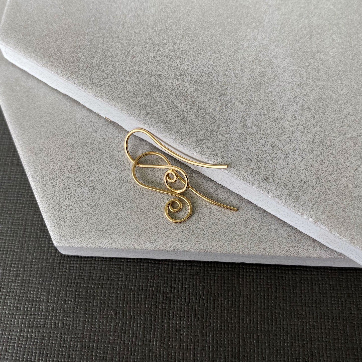Handmade 10K gold spiral earring hooks with a smooth, polished finish for a refined look.