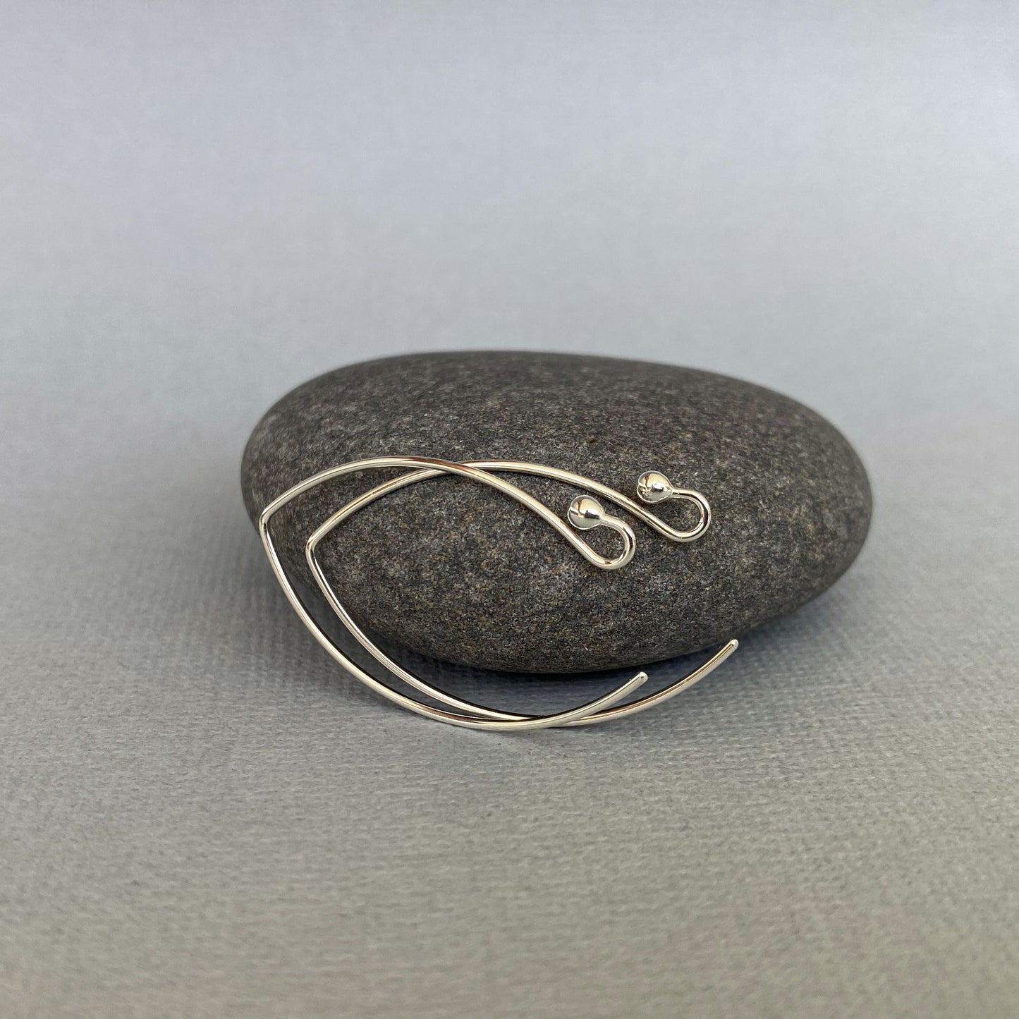 Detailed shot of the 2mm ball-end feature on handmade Argentium silver ear wires.