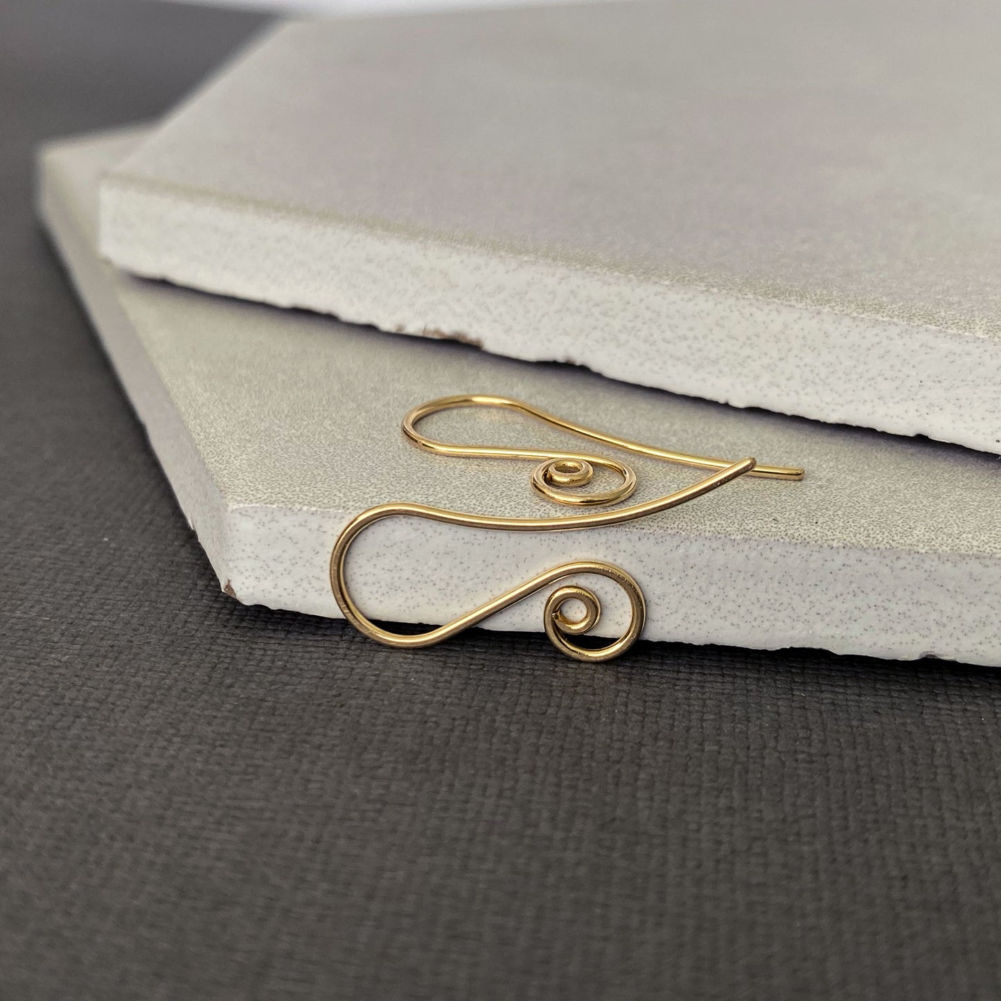Minimalist 10K gold earring hooks with a simple yet elegant spiral design, handmade with care.