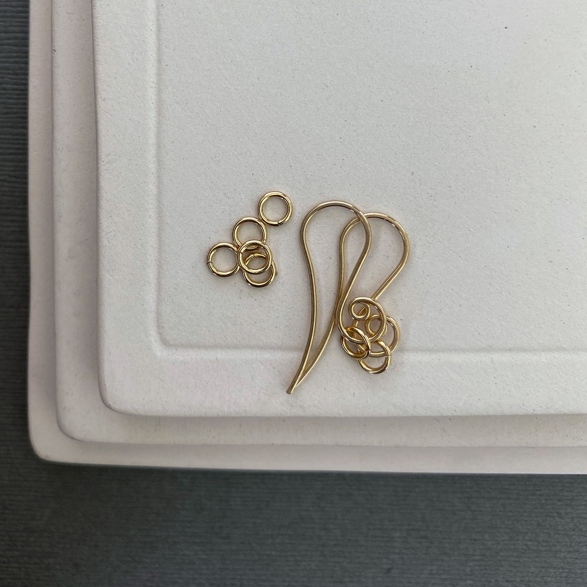 Precision-cut 10K gold jump rings, tumbled for strength and shine, shown from multiple angles.