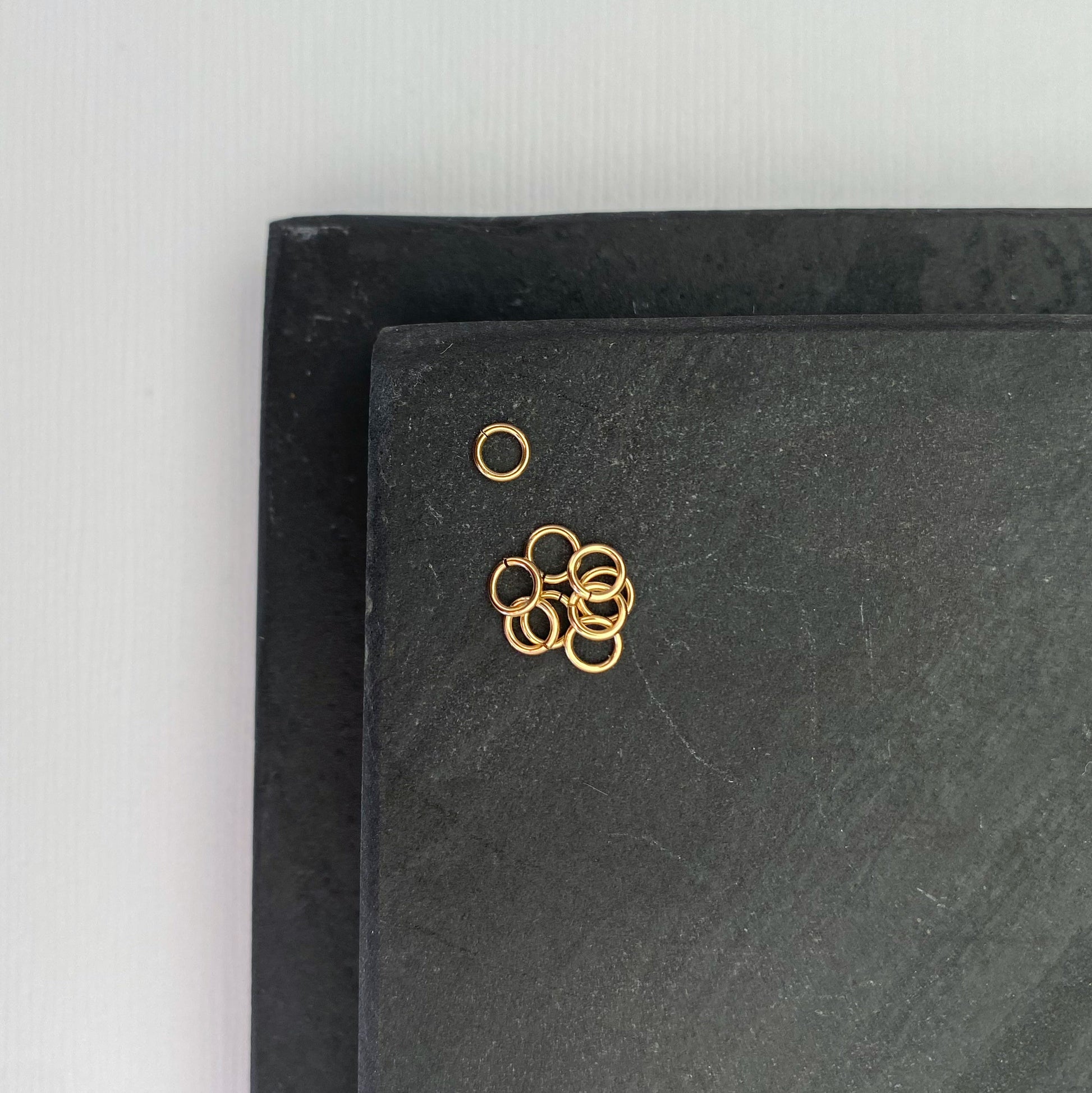 Tiny 2.5mm real gold jump ring with a polished finish.