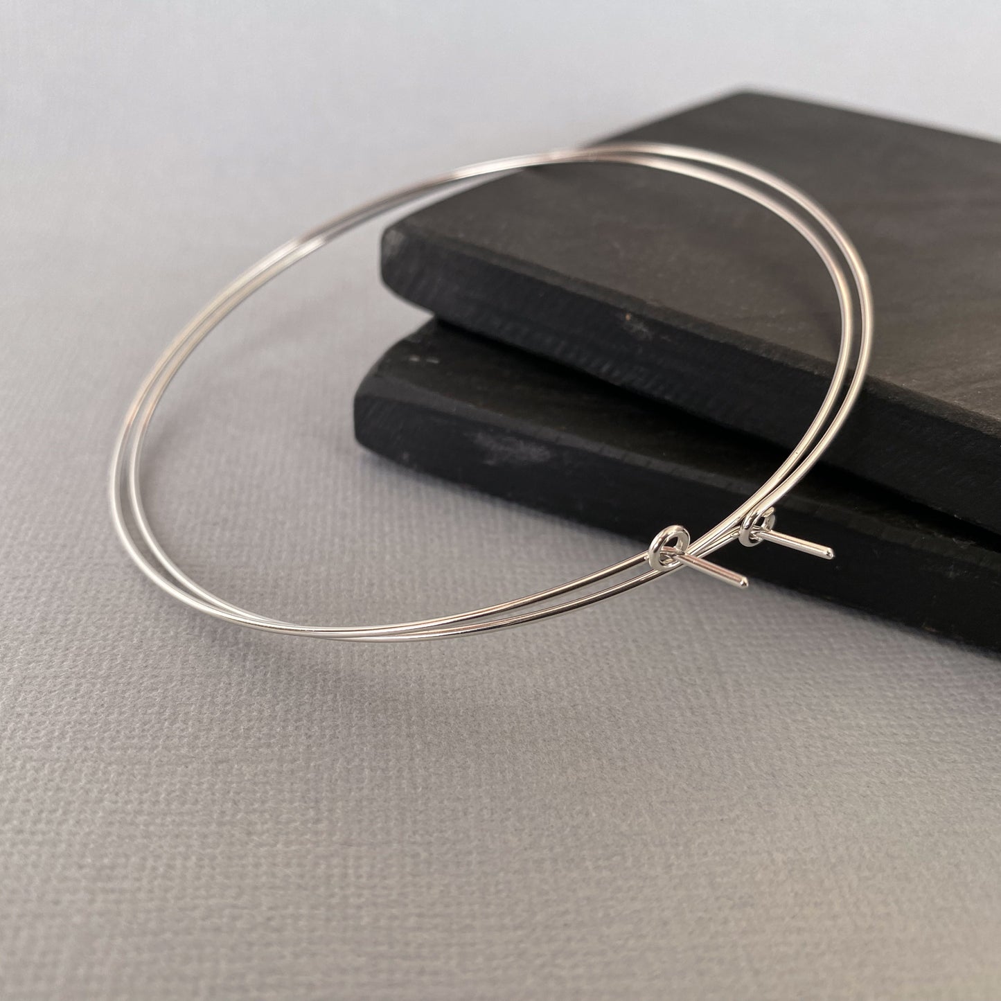 Close-up of the clasp mechanism on sterling silver hoop earrings, ensuring a secure and comfortable fit.