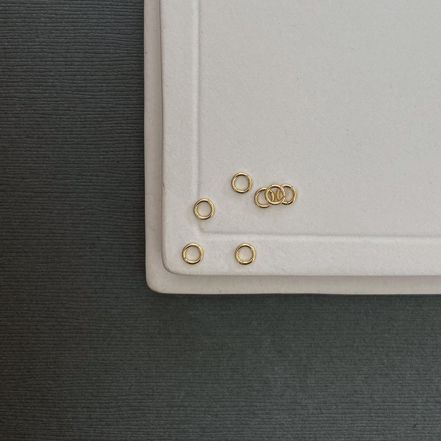 Small 3mm gold jump rings crafted from 20g wire, perfect for connecting charms and clasps.