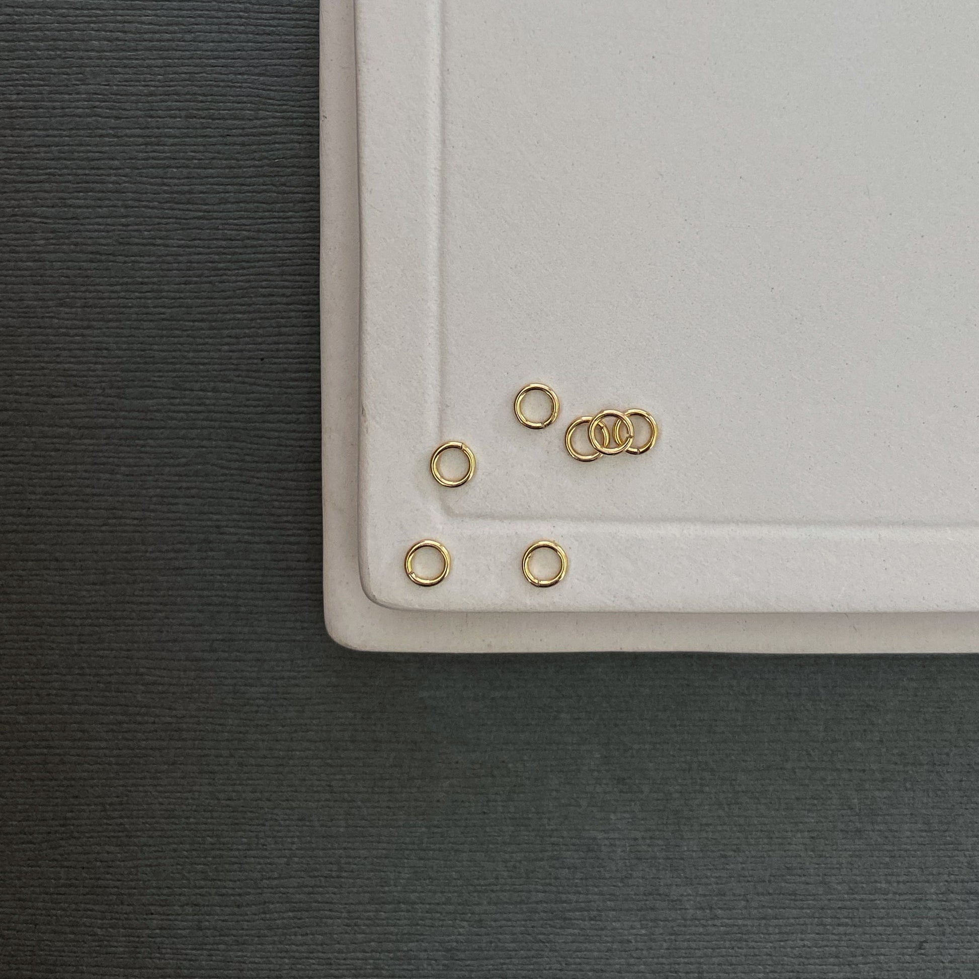 Small 3mm gold jump rings crafted from 20g wire, perfect for connecting charms and clasps.