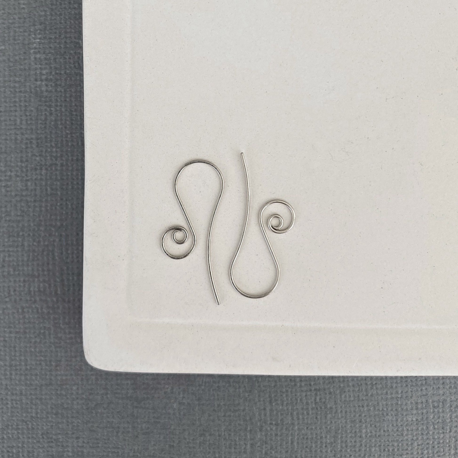 Handmade white gold earring hooks with hammered and flared design