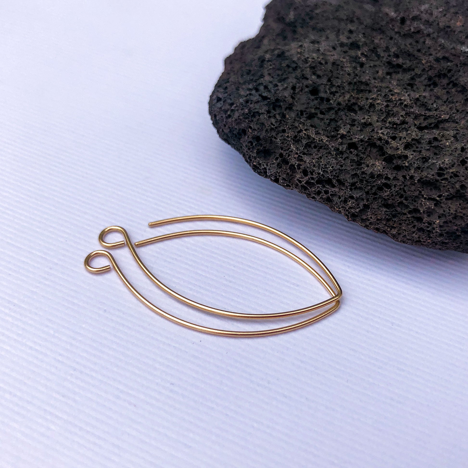 Close-up of 10k gold long ear hooks in 22 gauge with smooth ends for comfort.
