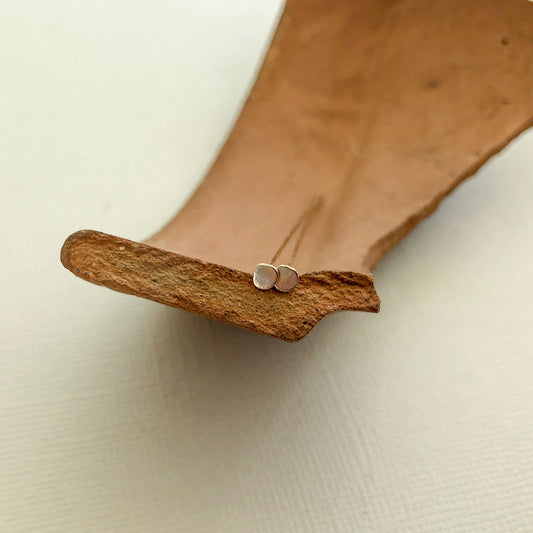 A pair of 2"Gold filled head pins resting on a broken clay planter organic round shape hand hammered