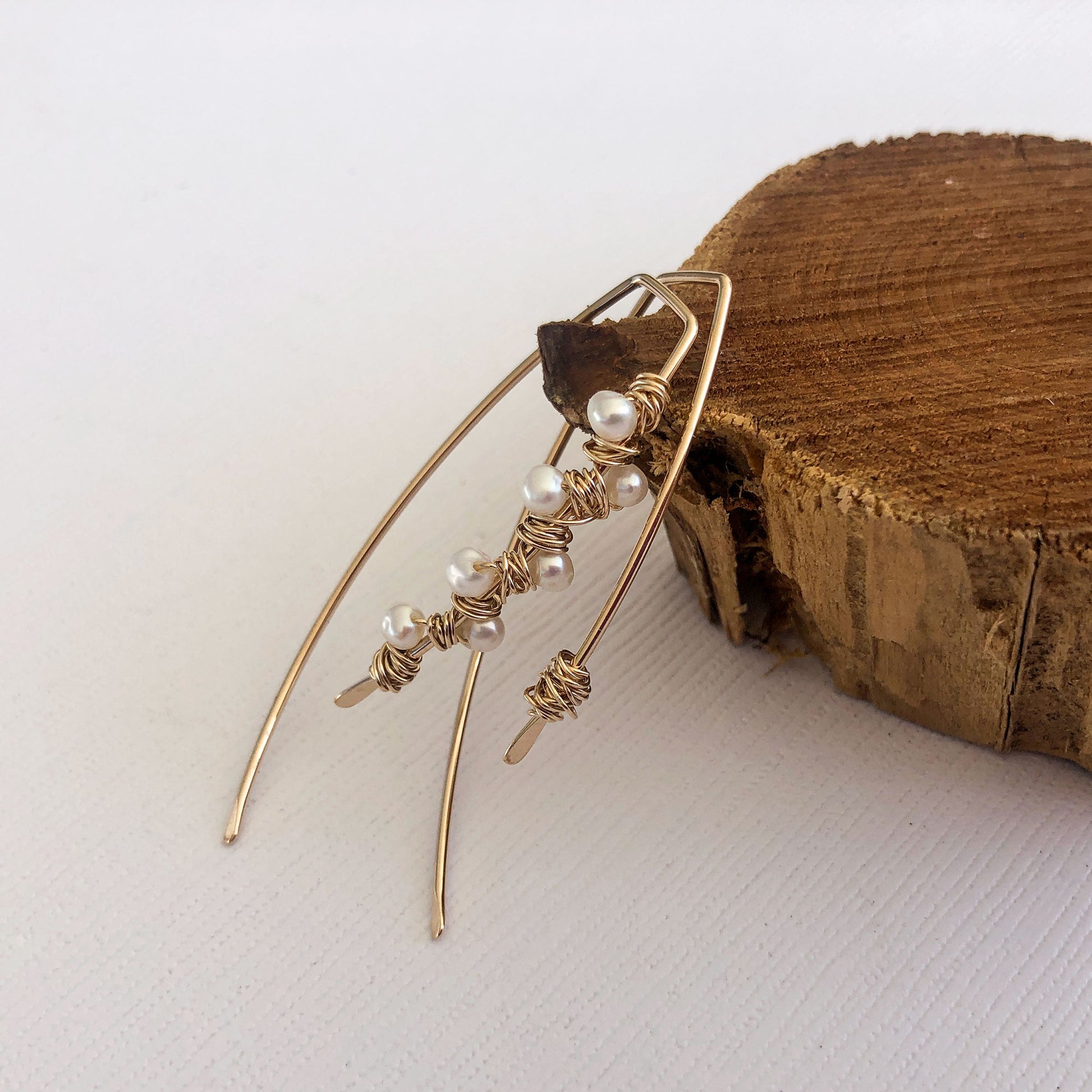 gold filled mismatched ear wires. one has pearls wrapped around it and the other has a messy wire wrap.  Hammered ends. These are sold by the pair.