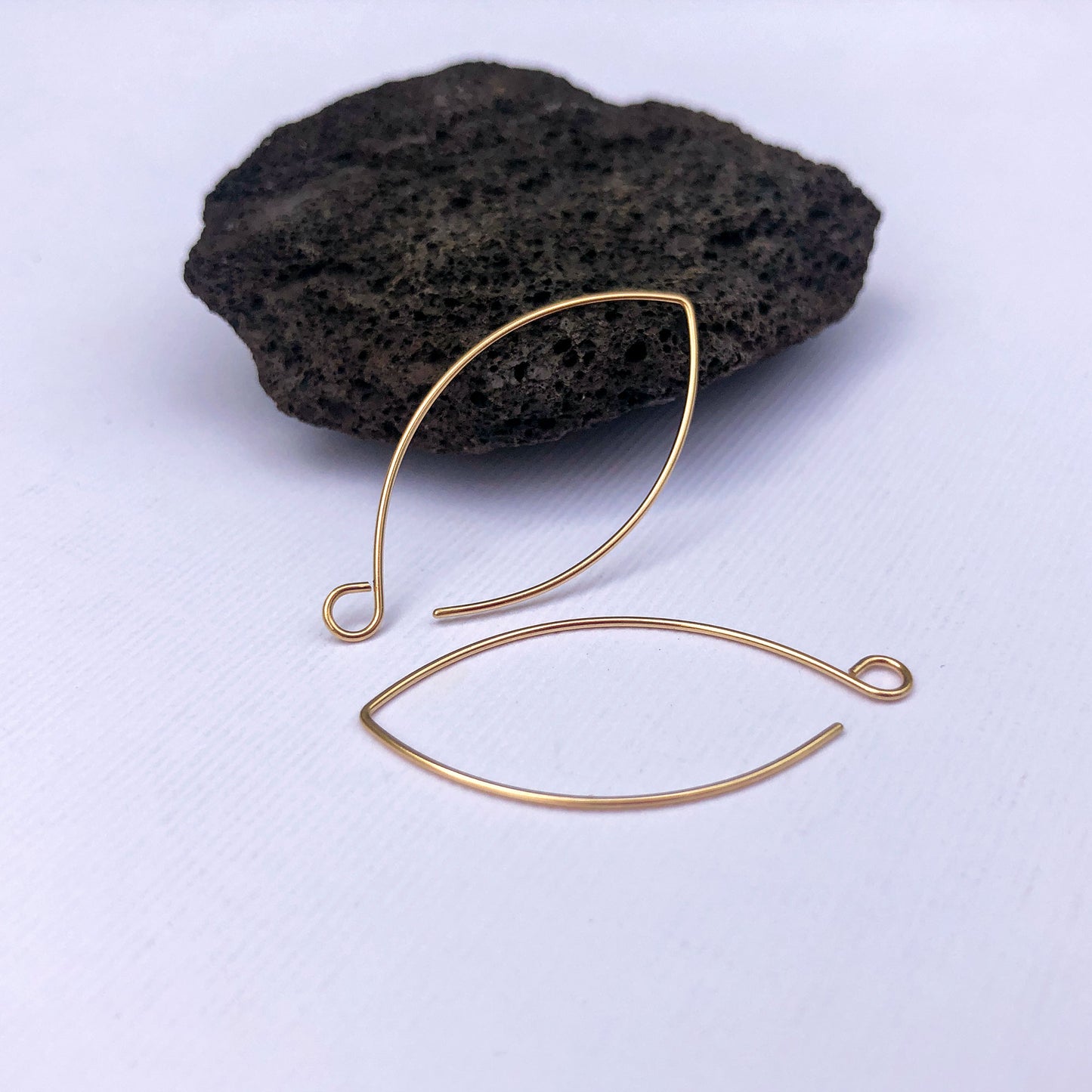 Handmade solid gold marquise ear wires in 14k gold, shown on white background.