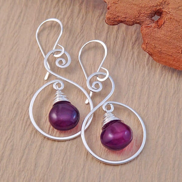 A pair of handcrafted spiral drop earrings made from sterling silver, designed with lightweight yet durable components.