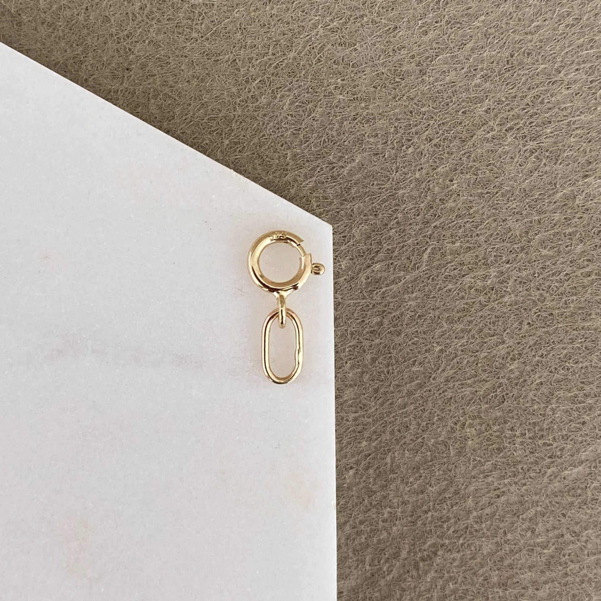 Handmade 14k solid gold chain extender and charm holder on white background