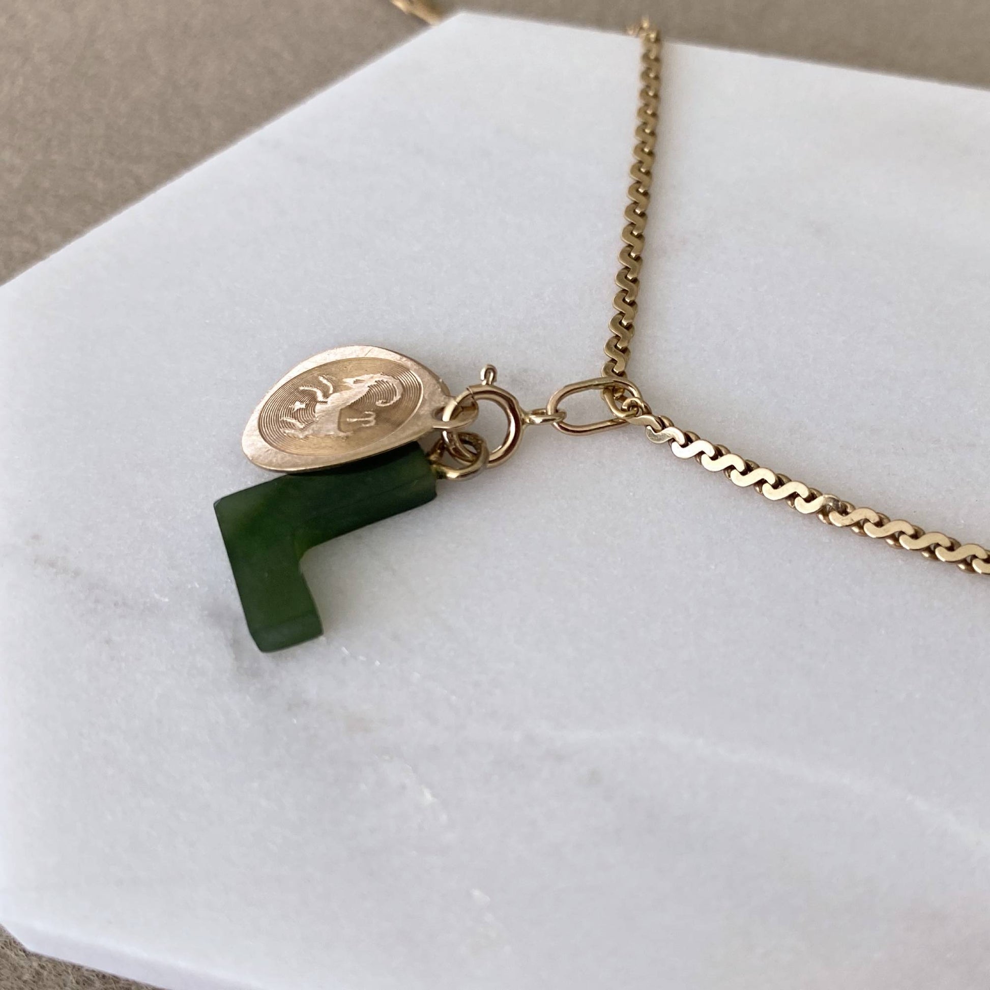 Handmade 14k gold charm holder with coin and jade letter charms attached