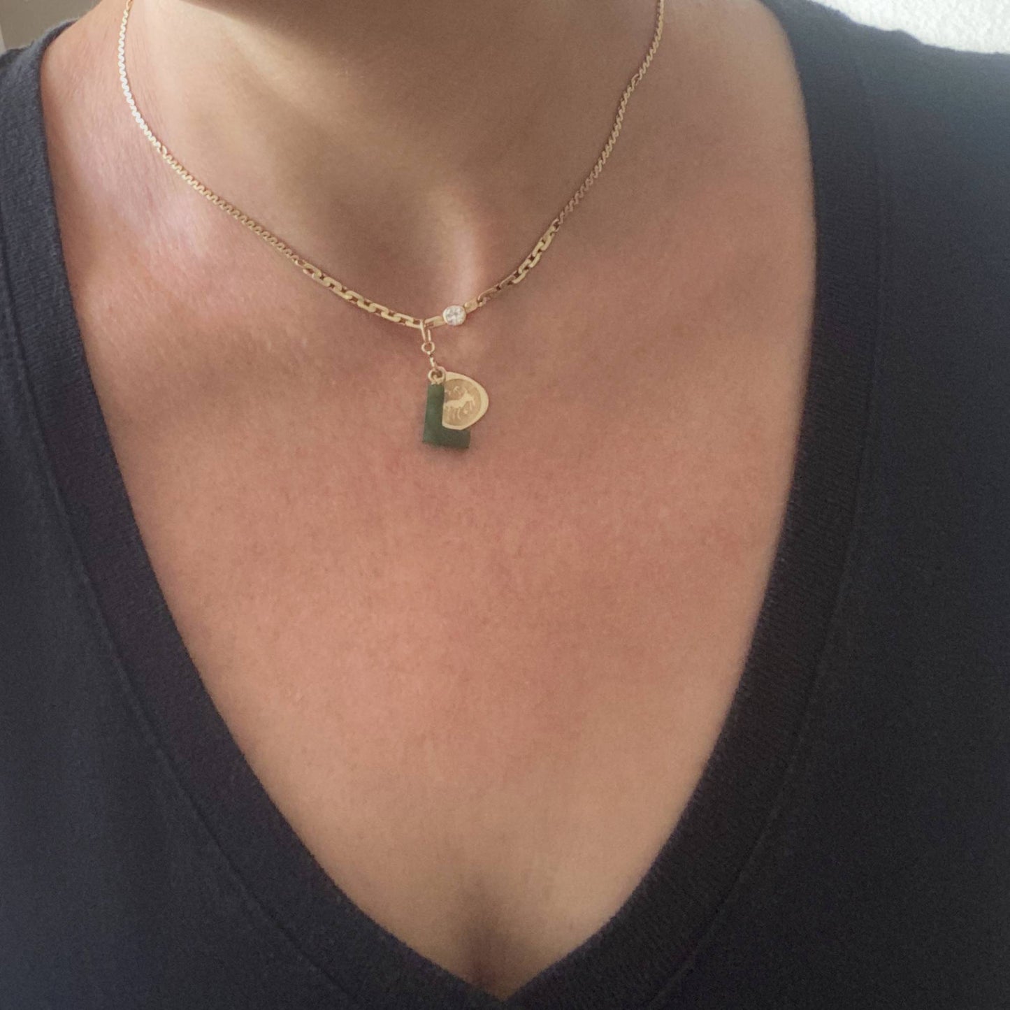 14k gold charm holder worn as necklace with charms showing lifestyle styling