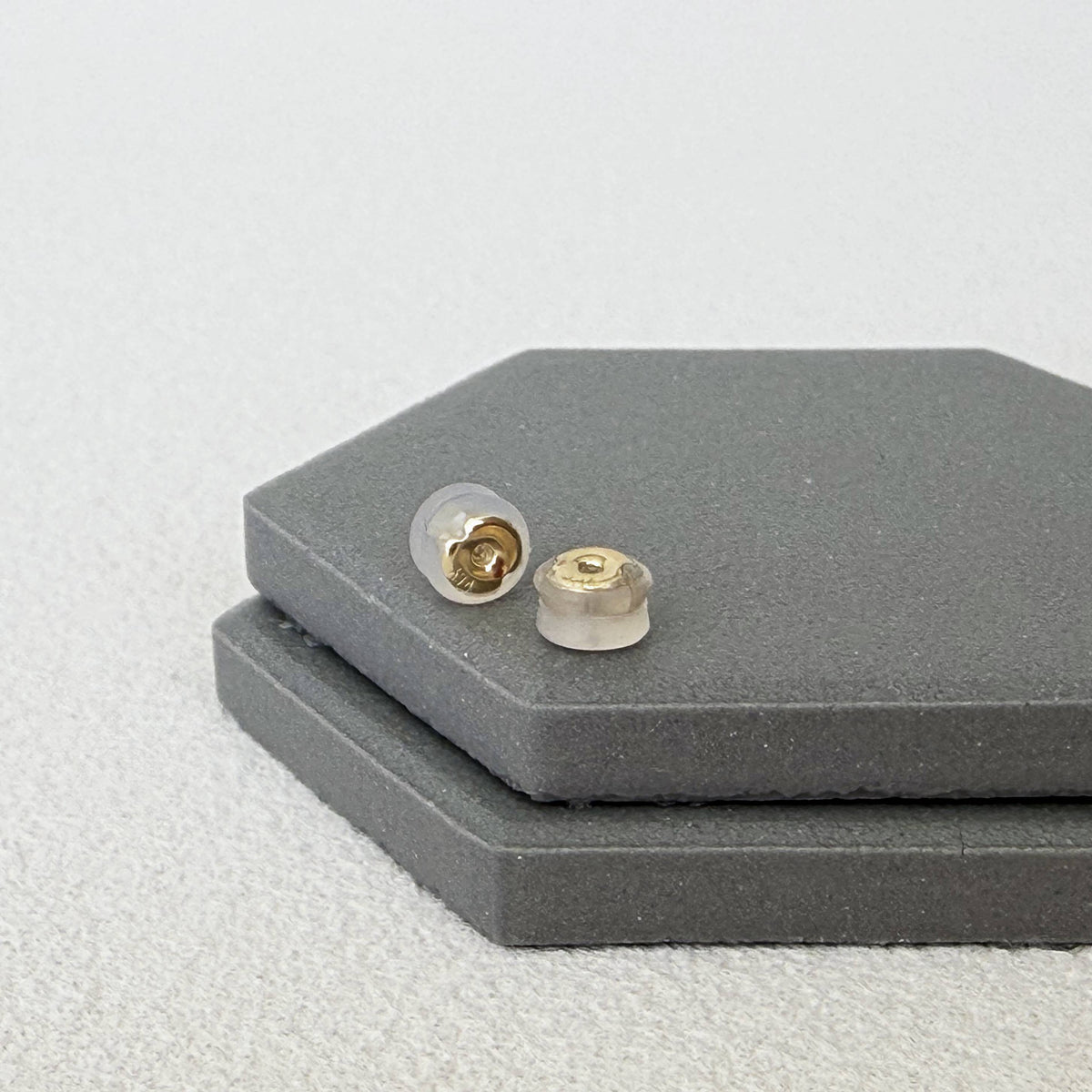 Close-up of 14K yellow gold silicone earring backs