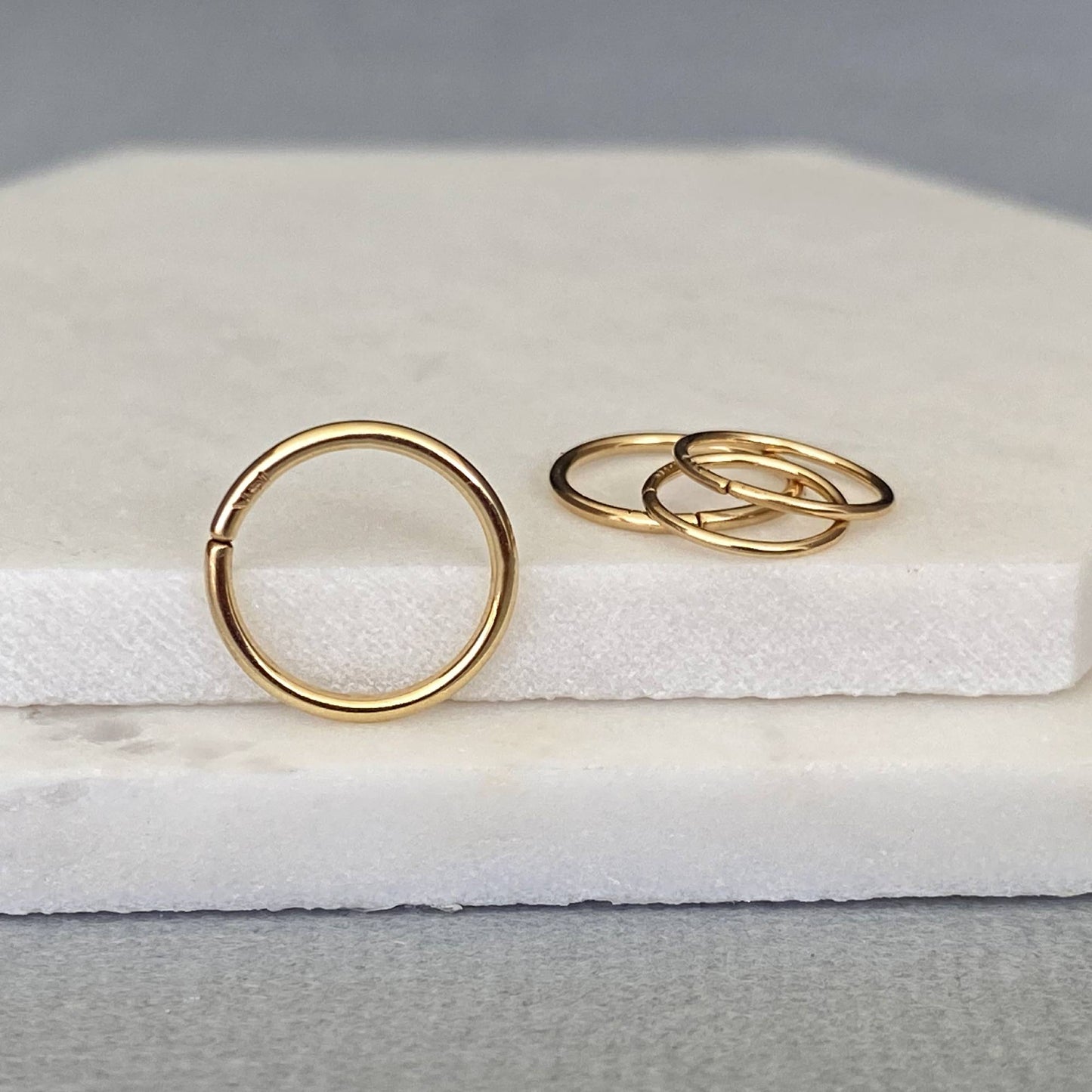 Handcrafted 14k solid gold seamless nose ring hoop with a high-polish finish.
