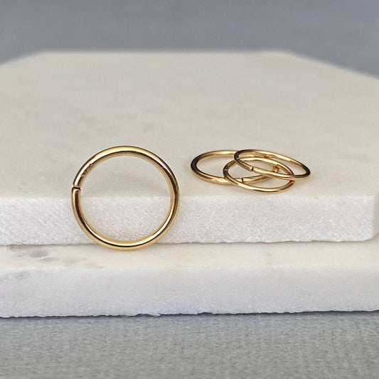 Handcrafted 14k solid gold seamless nose ring hoop with a high-polish finish.