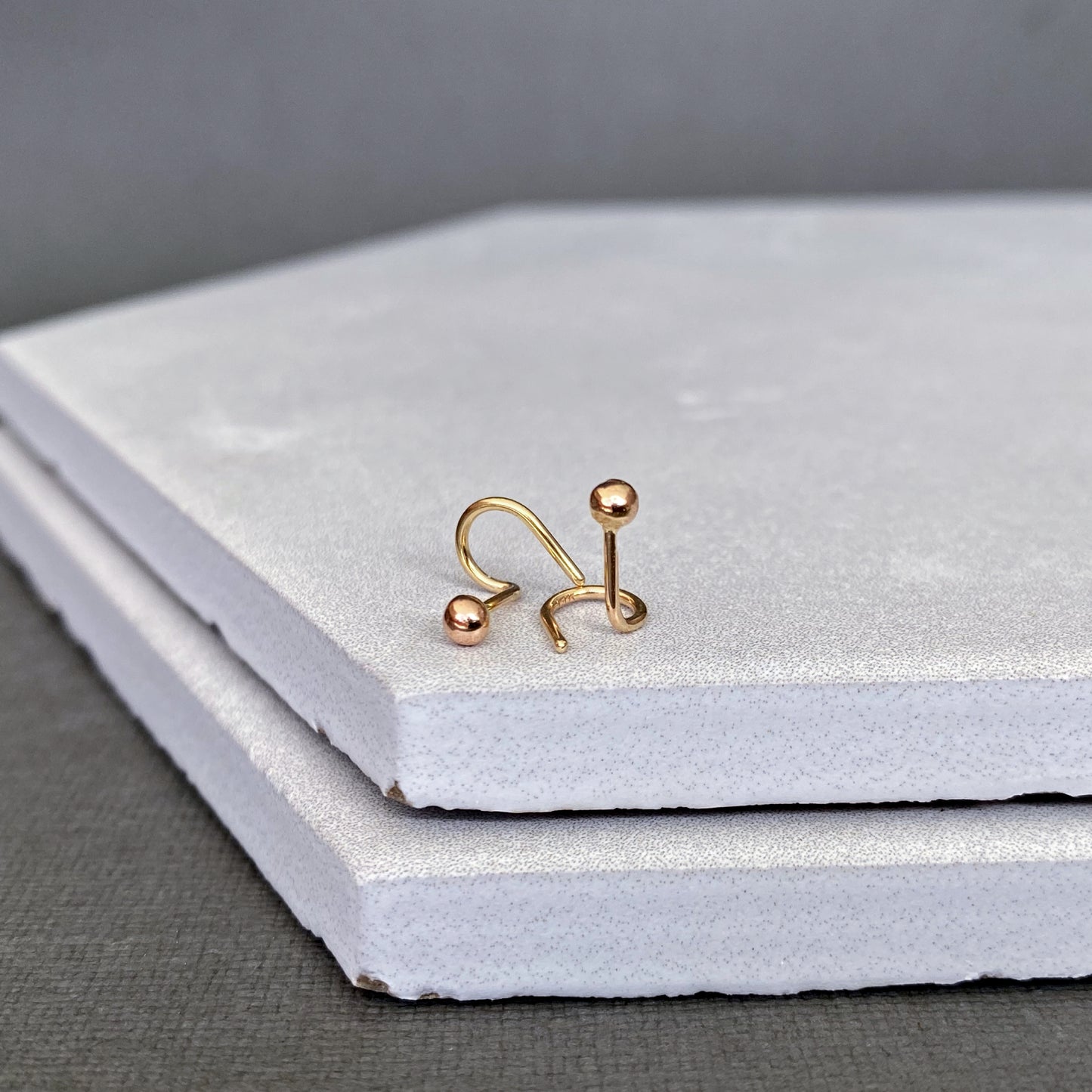 Detailed view of the 14k solid gold 3mm ball studs