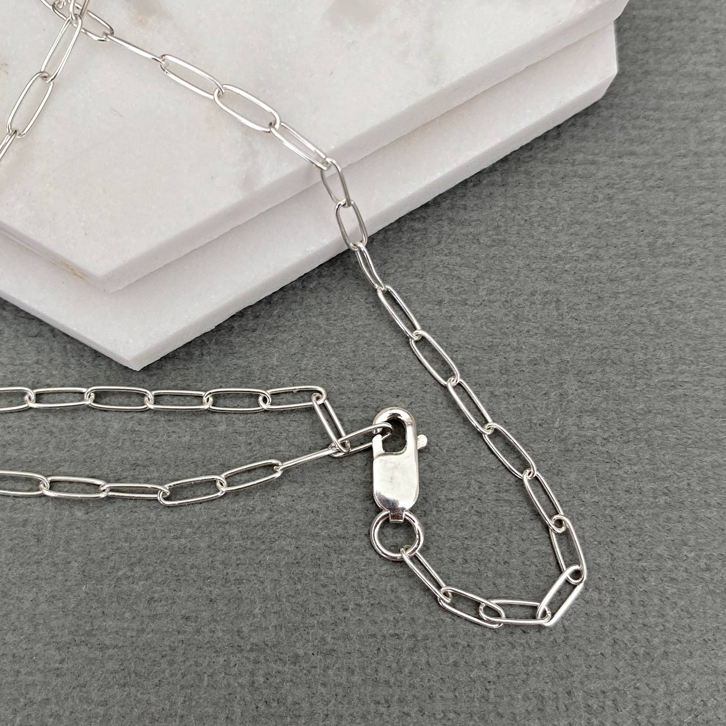 925 sterling Silver chain necklace with clasp on a gray surface
