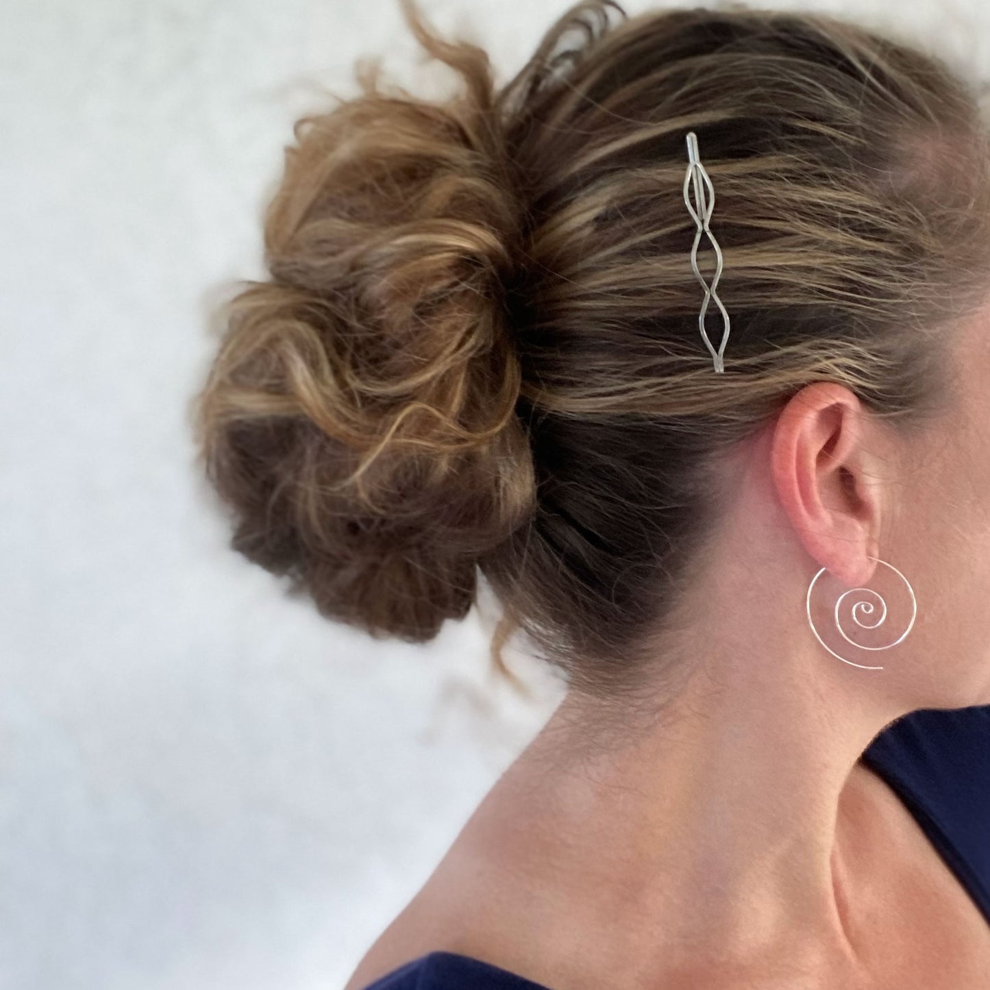 Large spiral hoop earrings.  Handmade, using solid sterling silver wire. Lightly hammered flat.