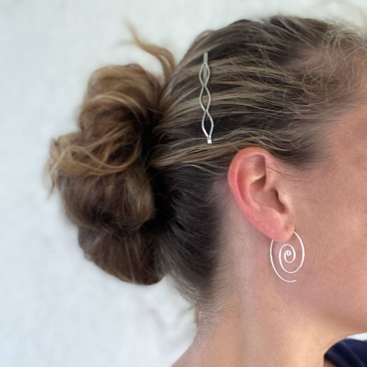 Large spiral hoop earrings.  Handmade, using solid sterling silver wire. Lightly hammered flat.