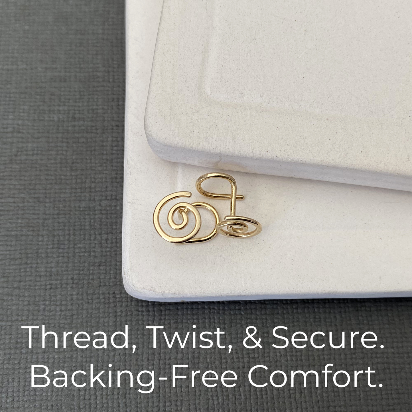 Gold hair tie on a white hair clip with text 'Thread, Twist, & Secure. Backing-Free Comfort.'