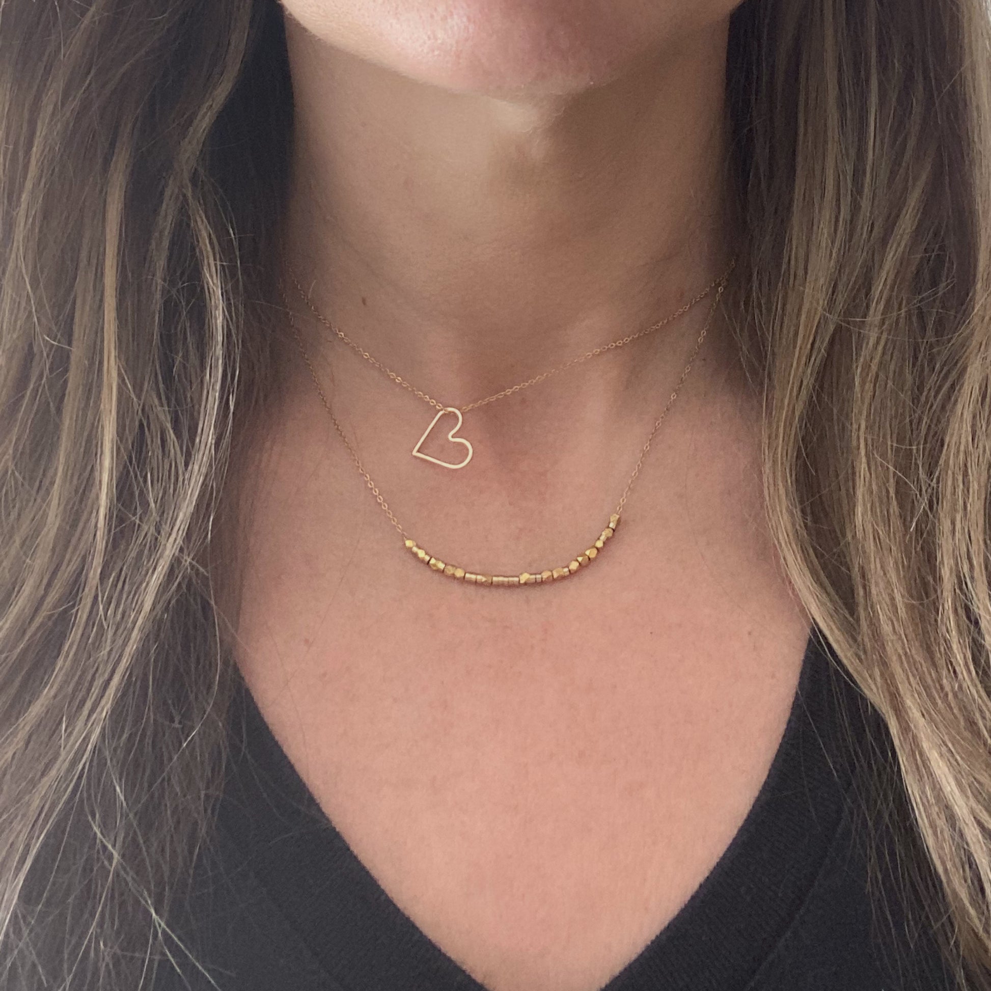 Two 14k gold filled custom-length chains laid side-by-side to show their versatility for a stacking look.