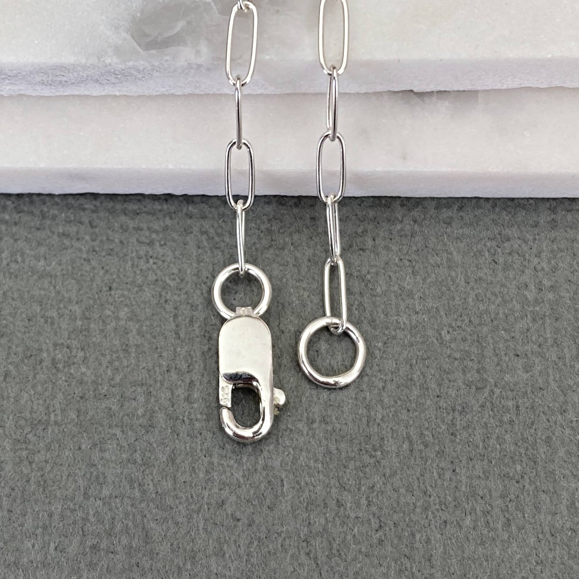 Safety breakaway paperclip necklace designed as a snag-free option for healthcare professionals.