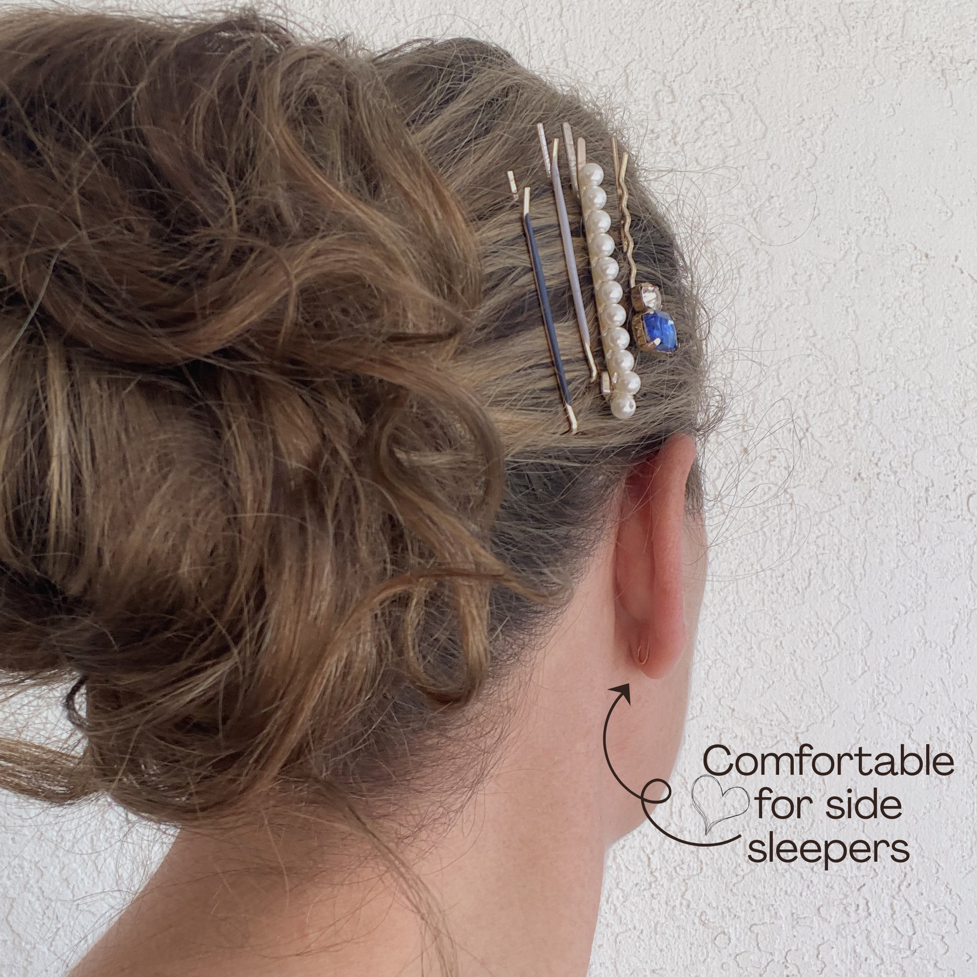 Person with hair styled with hairpins, showing comfort for side sleepers.
