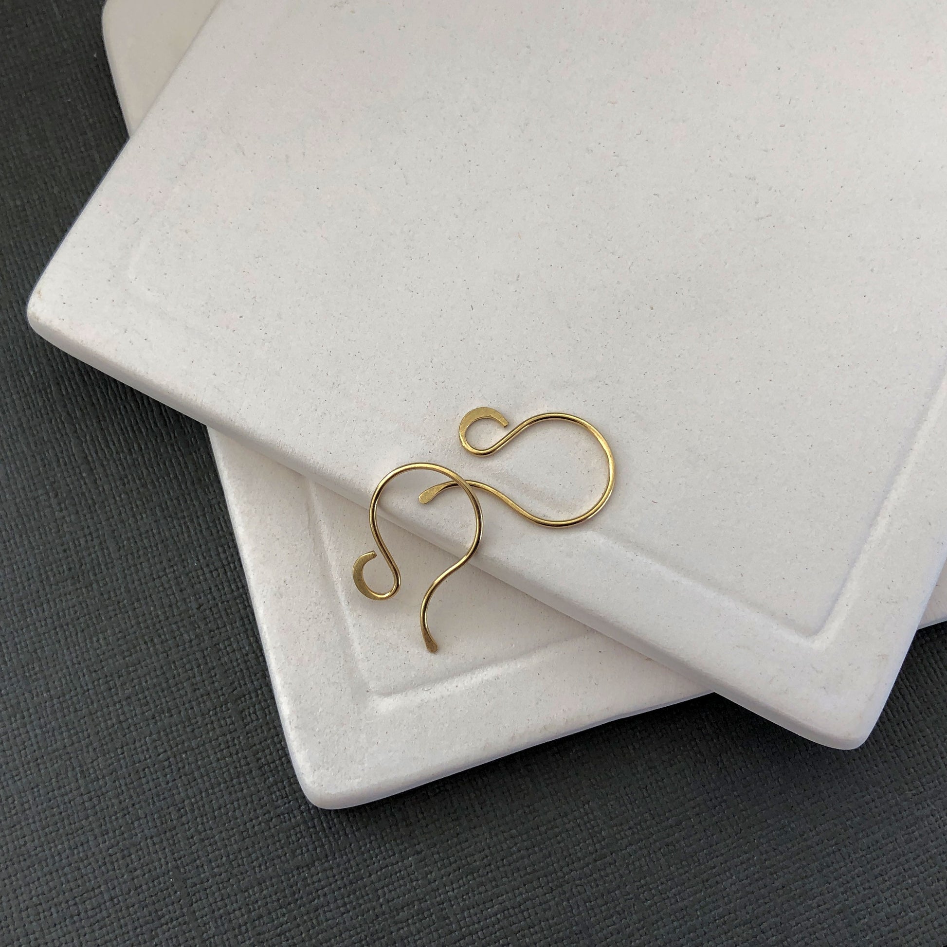 Macro shot of 18k gold French hooks showcasing craftsmanship