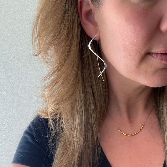 Handmade sterling silver threader earrings with a wave design and hammered finish, main product shot.