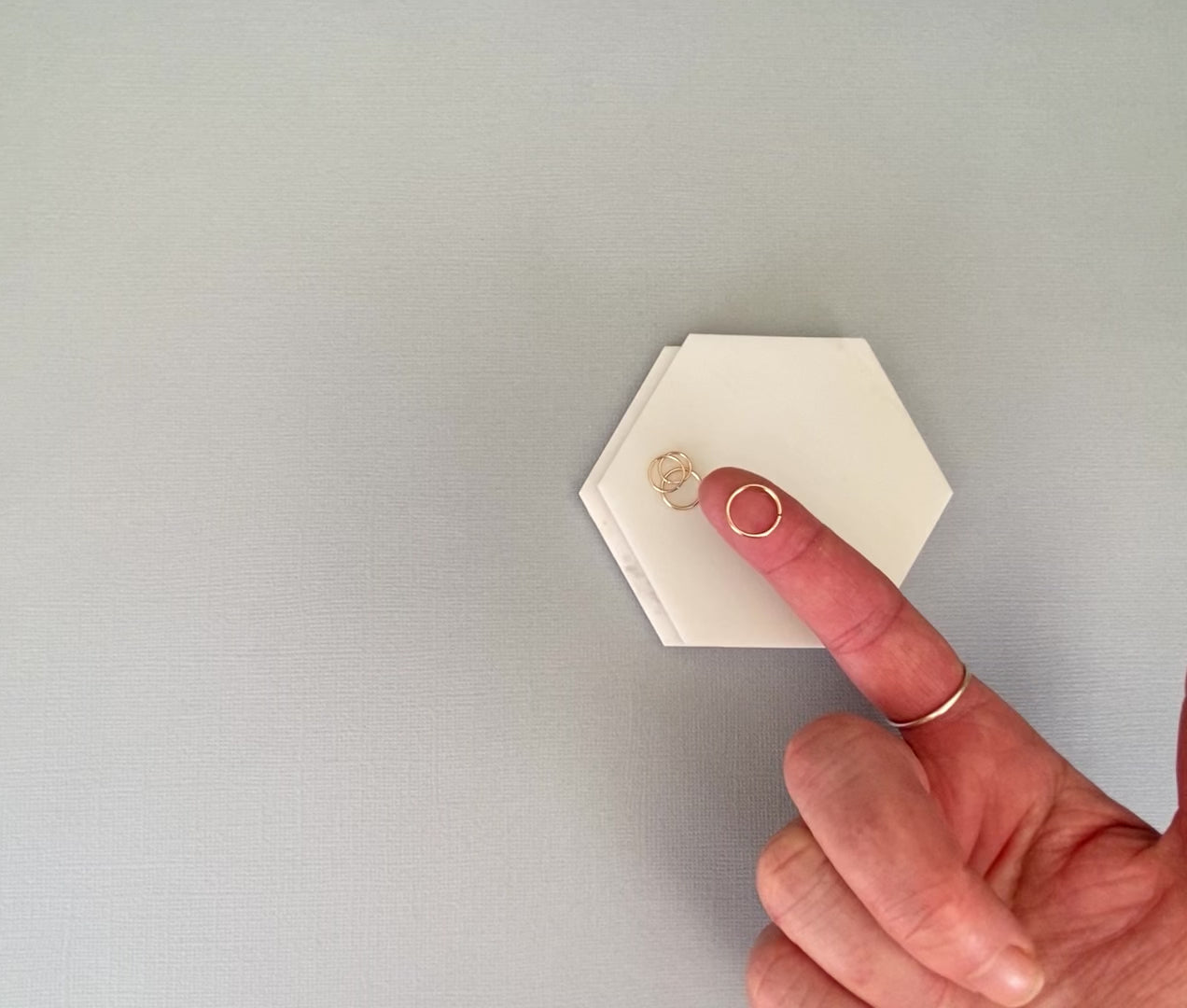 video of hand opening and closing a solid gold nose ring hoop