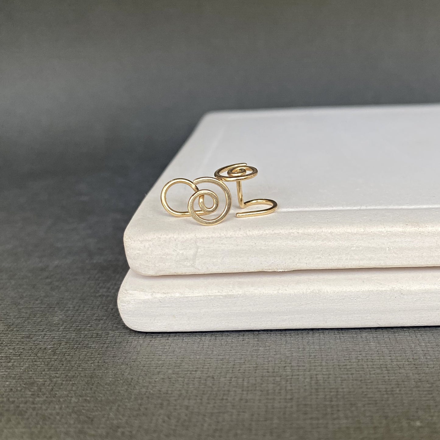 Gold ring with a floral design on a gray surface