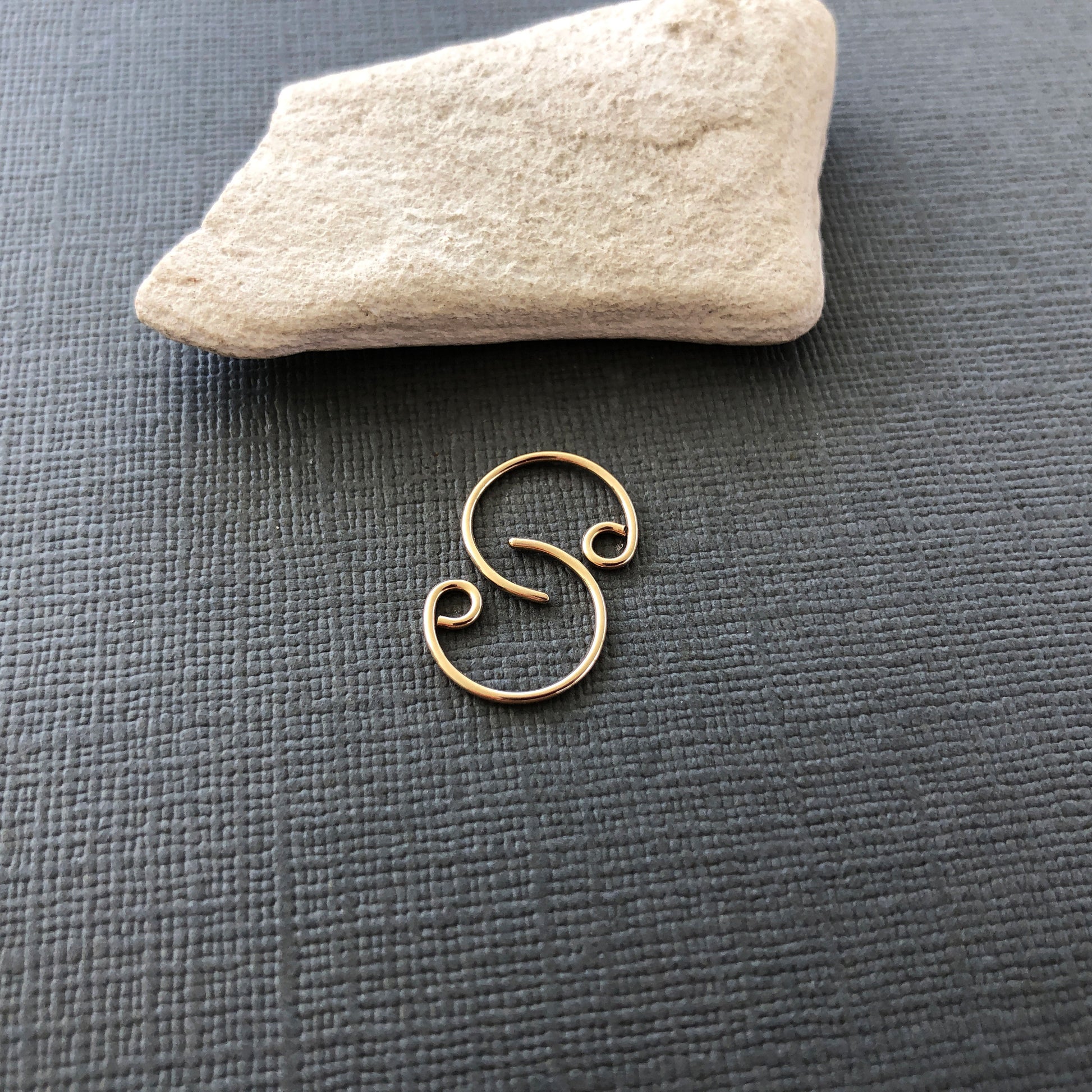 Stacked arrangement of tiny 14k gold filled hoop earrings