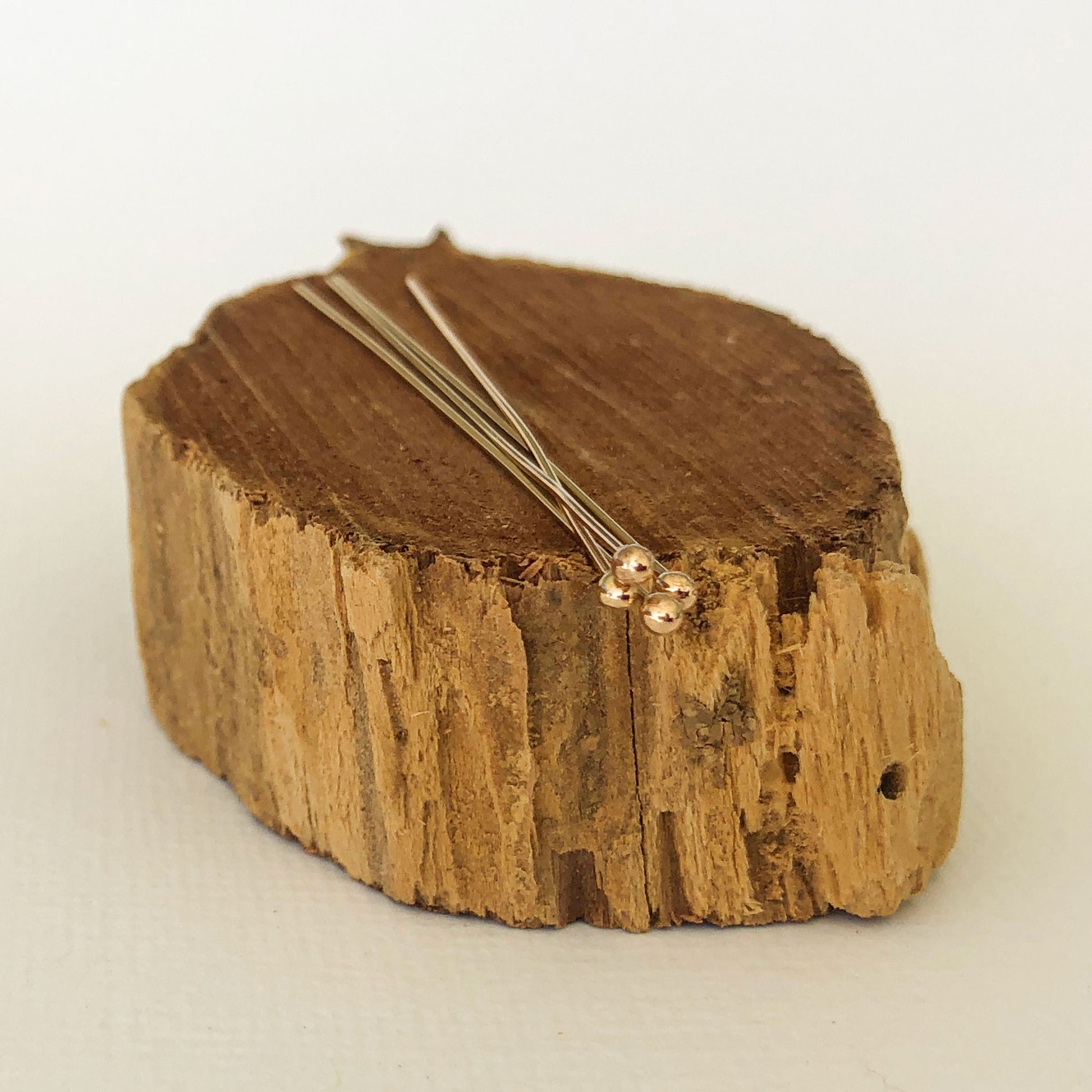 ball head pin made with gold balls and gold filled stems, used for jewelry making